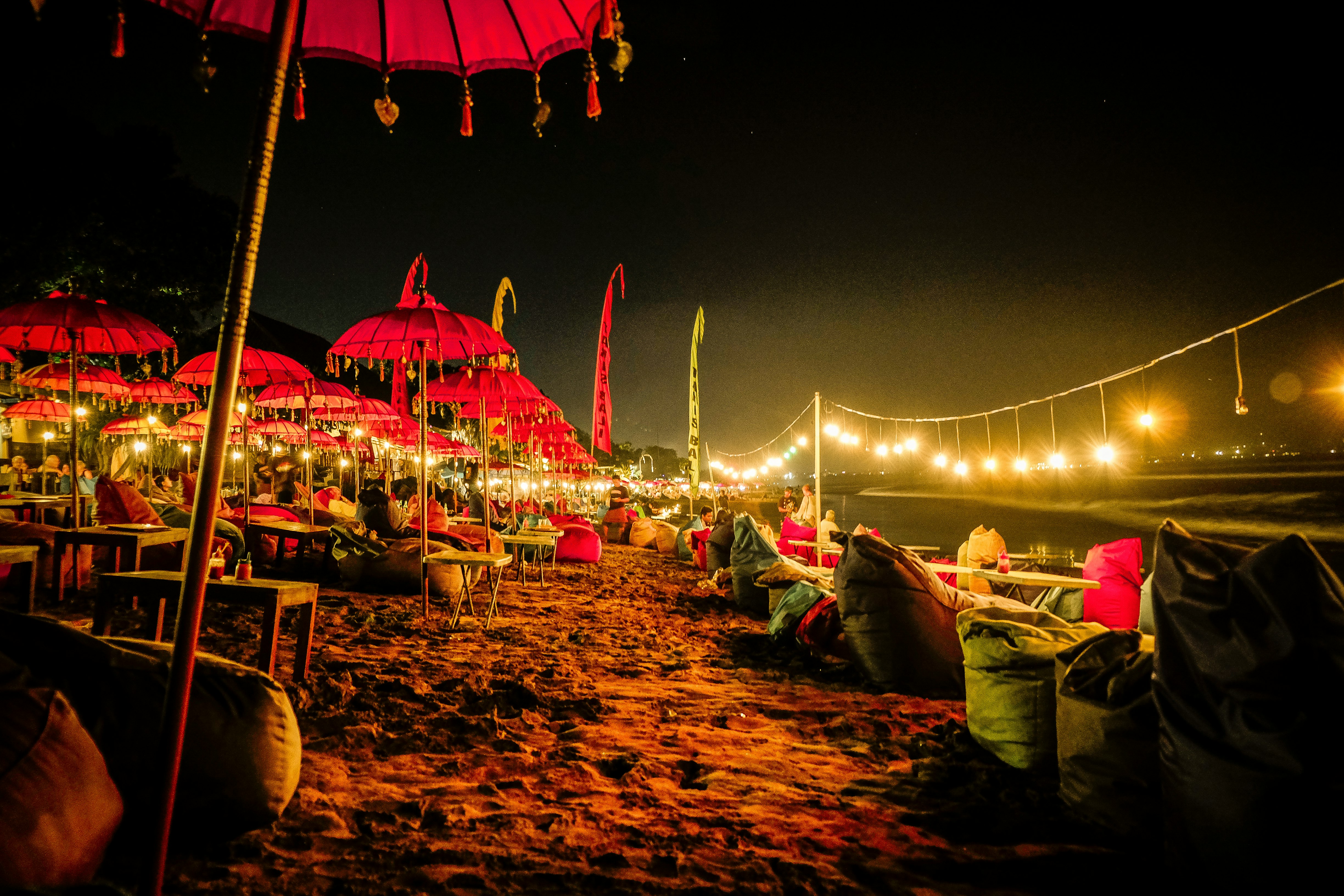 red umbrellas and yellow lights on shore